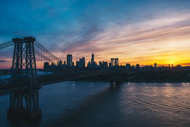 Williamsburg Bridge with Manhattan skyline at sunrise