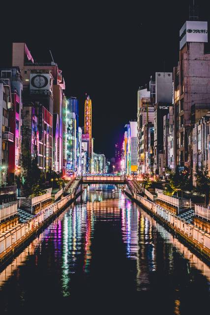 Osaka canal at night with neon reflections and illuminated buildings